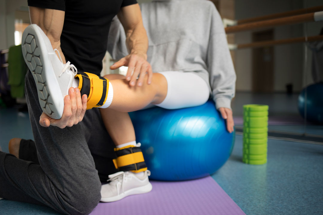 patient doing physical rehabilitation helped therapists