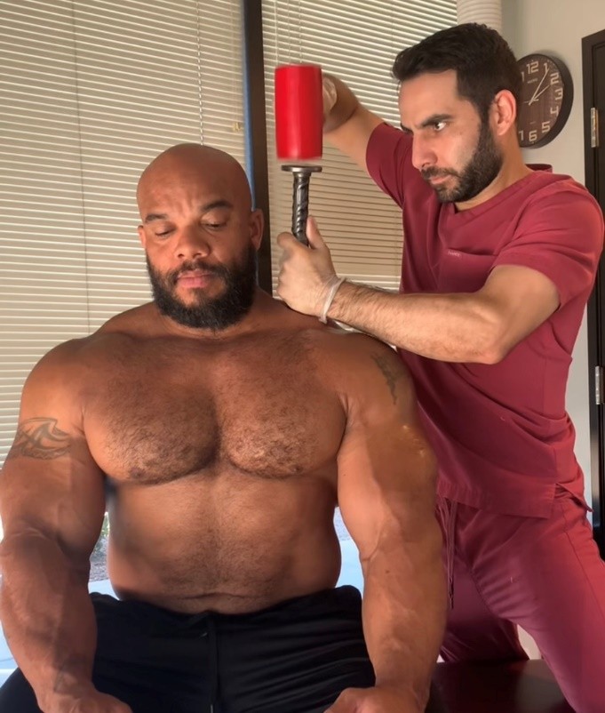 Dr. Gamero in Hammer Therapy session with IFBB Body Builder Sergio Oliva Jr.