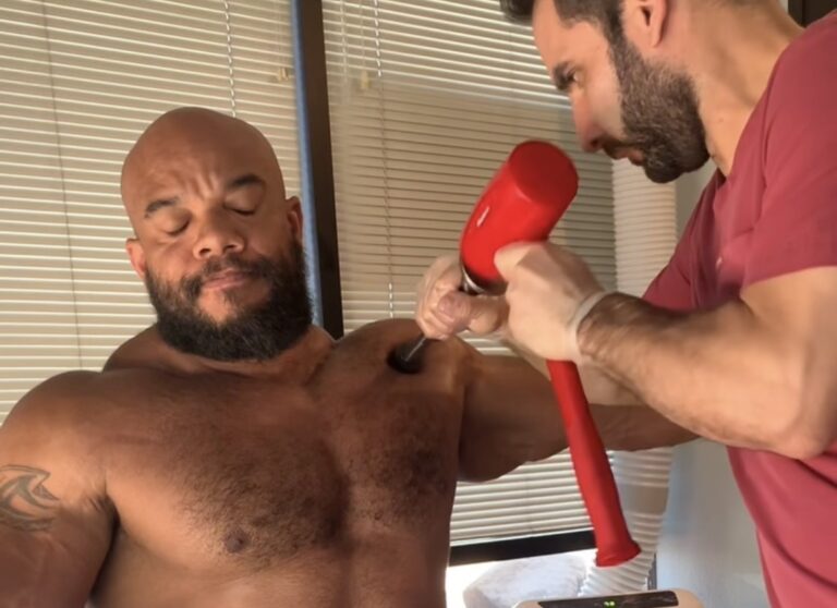 Dr. Gamero in Hammer Therapy session with IFBB Body Builder Sergio Oliva Jr.