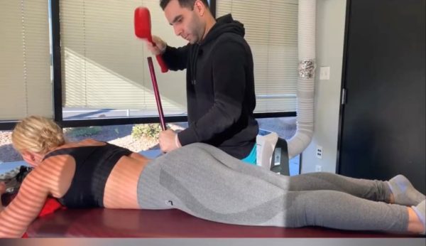 Dr. Gamero in Hammer Therapy session with Pro Strong Woman Brittany Diamond